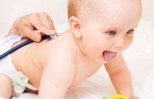 Pediatric doctor exams little baby girl with stethoscope